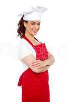 Side view of cheerful chef posing casually