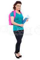 Student with backpack and spiral notebook