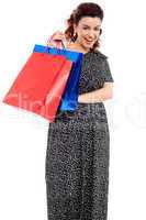 Profile shot of woman holding shopping bags