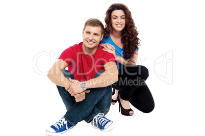 Trendy adorable love couple sitting on floor