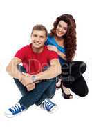 Attractive love couple sitting relaxed on floor