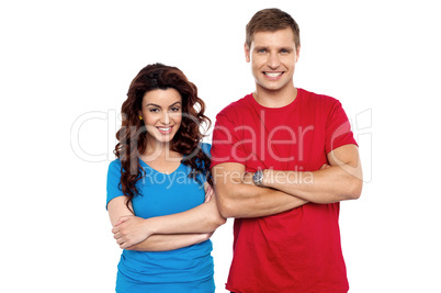 Attractive couple posing with arms crossed