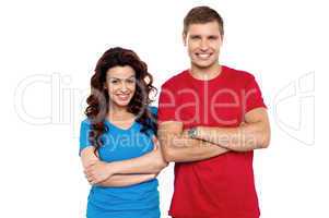 Attractive couple posing with arms crossed