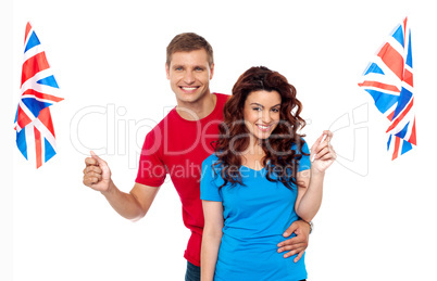 Young love couple embracing and holding national flag