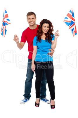Guy hugging his girlfriend and both holding UK flag