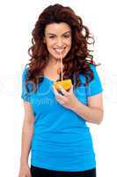 Fit girl drinking fresh orange juice directly from fruit