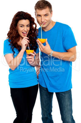 Young couple drinking orange juice together