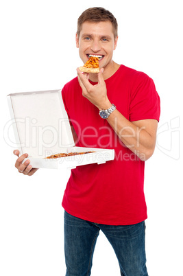 Cool young guy enjoying pizza