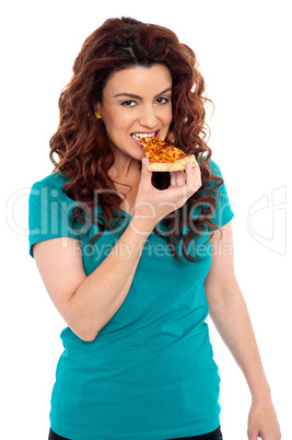 Trendy casual girl enjoying her piece of pizza