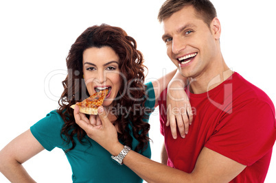 Boyfriend making her girl eat hot pizza piece