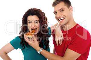 Boyfriend making her girl eat hot pizza piece