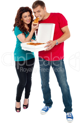 Couple enjoying pizza together, great bonding