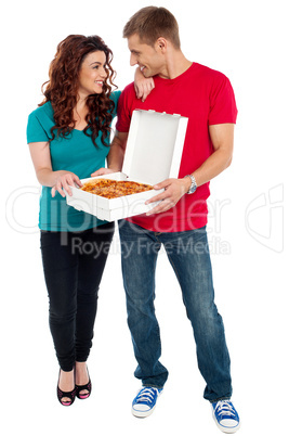 Love couple sharing pizza. Enjoying together