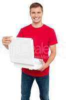 Smiling casual man holding pizza box