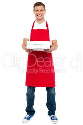 Full length portrait of male chef holding pie box