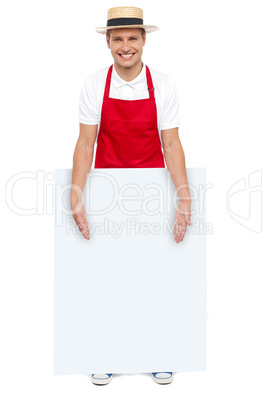 Male chef presenting you blank advertising board