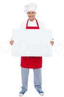 Chef holding blank white billboard. Full length shot