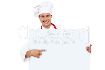 Chef pointing at the blank white billboard