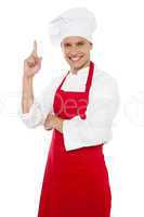 Happy smiling chef showing index finger