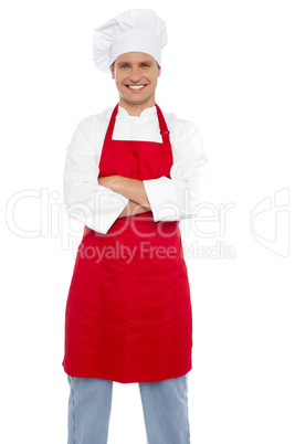 Confident cheerful male chef with arms crossed