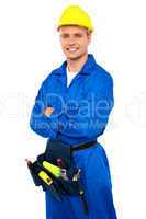 Young contractor with tool set and arms crossed