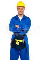 Young industrial contractor posing with crossed arms