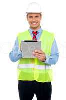Male construction engineer using tablet pc