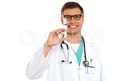 Doctor with an injection needle with white fluid