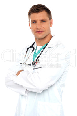 Handsome young doctor posing with crossed arms