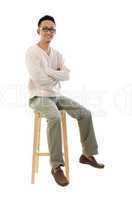 Full body Asian man sitting on a chair