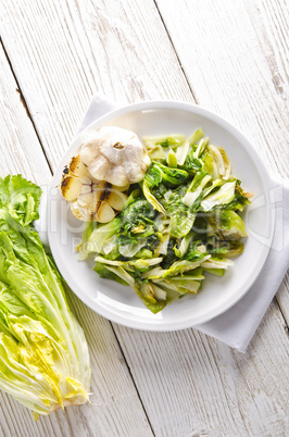 baked Romaine lettuce with garlic and pine cores