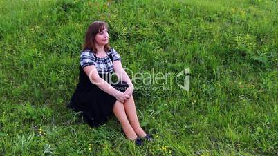 Couple Sits On Grass