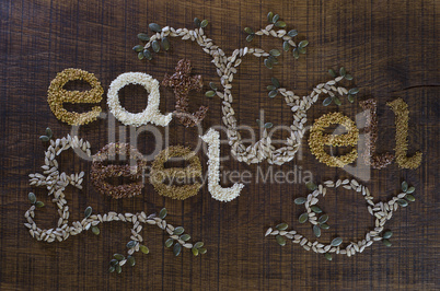 the phrase 'eat well, be well', written and decorated in seeds