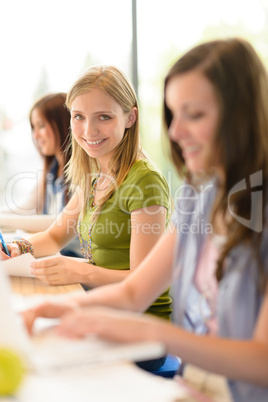 Happy female students in classroom