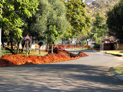 Speed-bump sign with large sand heaps