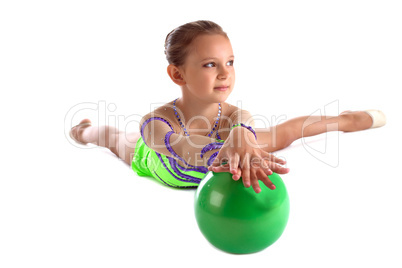 Kid gymnast lay with green ball