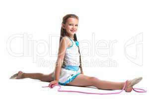 Young child gymnast doing split with skipping rope