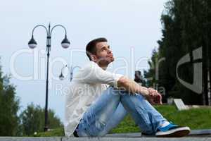 sad man relax in summer city park