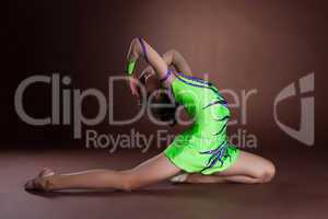 Dramatic kid in gymnast costume posing