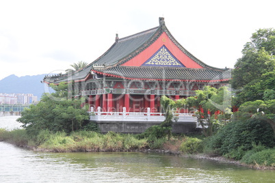Red wooden temple on the bank