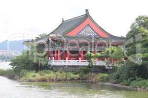 Red wooden temple on the bank