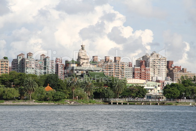 Statue and buildings on the bank of Lotus pond