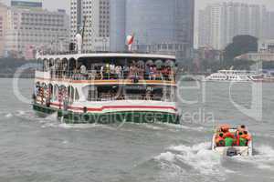 Big ferry and small motorboat