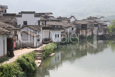 Houses on the riverbank in Shexian