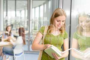 High school student read book by window