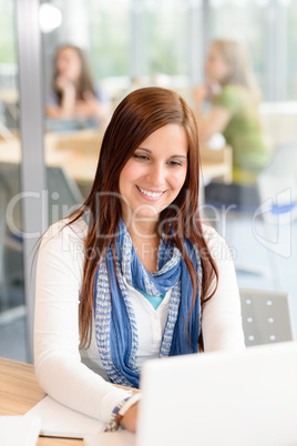 High school student typing on laptop