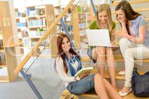 Group of high school classmates study library