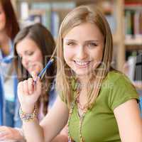 Smiling teenage student girl at study room