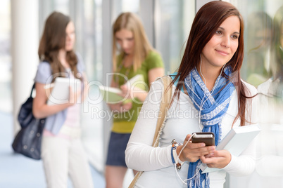 Smiling student listen music at high school