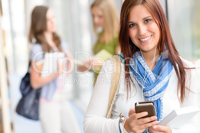 Smiling student listen music at high school